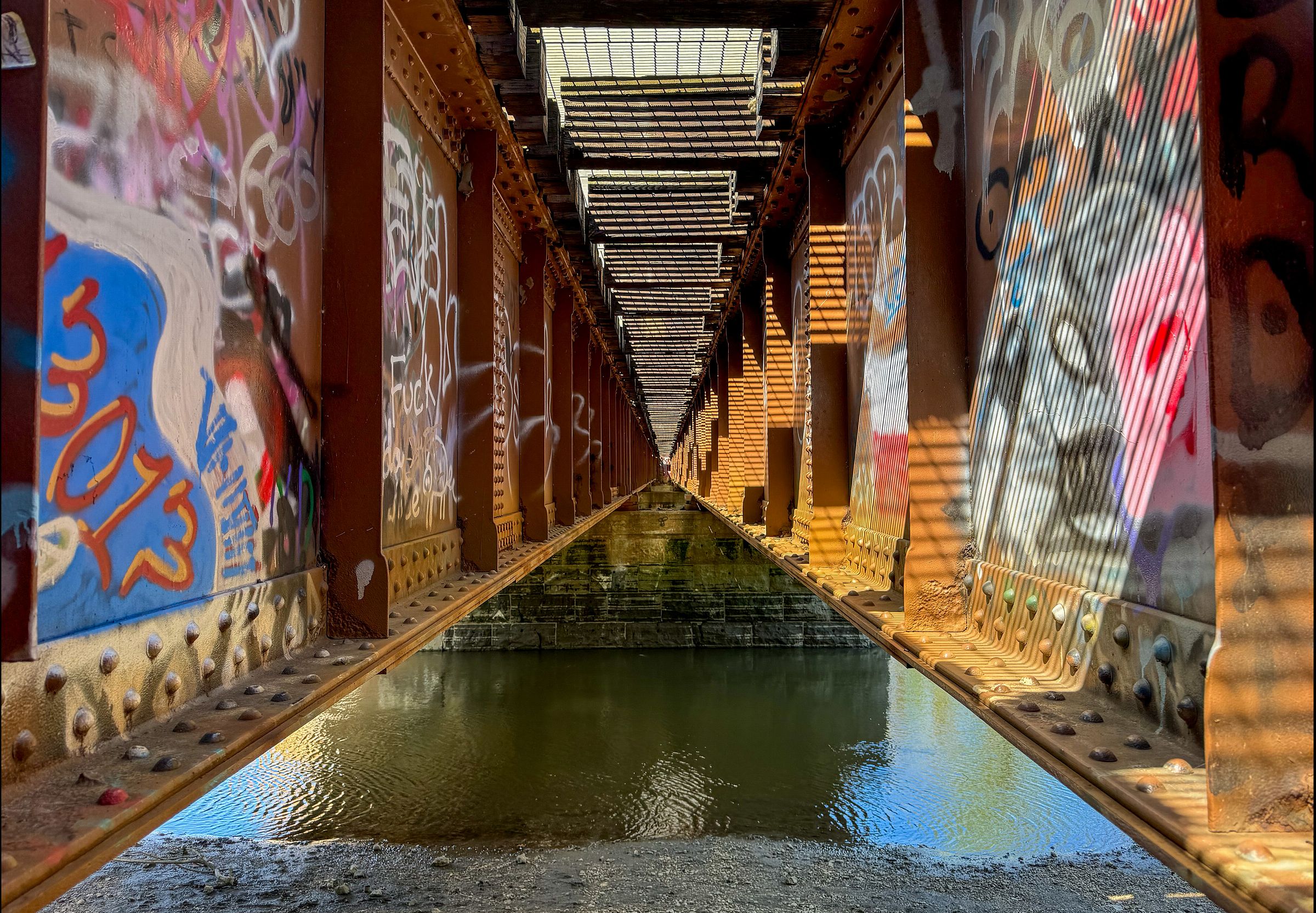 graffiti half-covered by worse graffiti. I imagine the paint, running, screaming